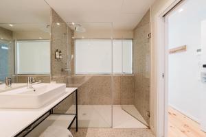 a bathroom with a sink and a shower at Liberator Rossio in Lisbon