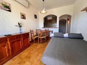 a living room with a couch and a table at Basic Comfort Studio Poblat tipic 0168 in Empuriabrava