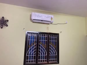 a wall with a window with a air conditioner on it at Lakeside Room stay in Yelagiri