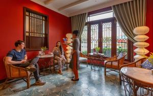 a man and a woman sitting in a waiting room at Savvy in Hoi An - The Essence of Refined Retreat in Hoi An +67 photos