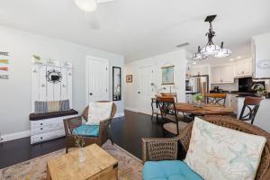 a living room with a table and chairs and a kitchen at Weeden Cottage in St. Augustine +64 photos