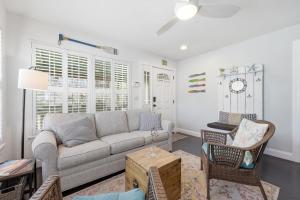 a living room with a couch and a chair at Weeden Cottage in St. Augustine