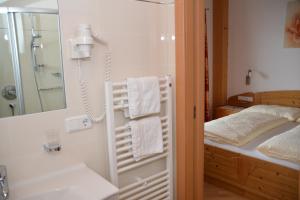 a bathroom with a shower and a sink and a mirror at Eichmannhof in Marlengo