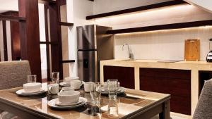 a kitchen with a table with plates and glasses on it at Casa San Martín, Campeche #1 in Campeche