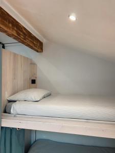 a bed sitting on top of a loft bed at Shifting Sands Surf House in Labenne