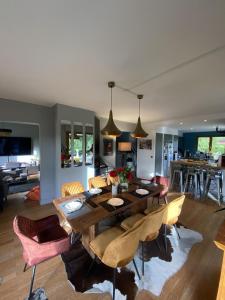 a dining room and living room with a table and chairs at Villa Crysaële in Menthon-Saint-Bernard