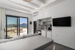 a living room with a couch and a television at Villa Leuki in Adamantas +41 photos