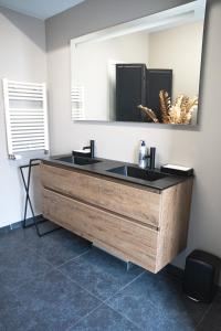 a bathroom with a sink and a mirror at Maison Malo in As