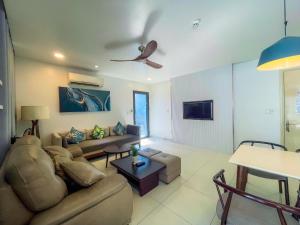 a living room with a couch and a ceiling fan at Villas 930 Oceanami in Long Hai