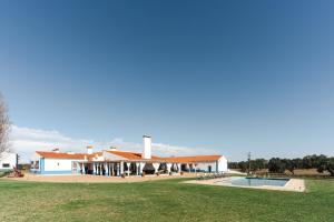 a large house with a swimming pool in front of it at Charming Farm House With Pool in Ferreira do Alentejo +107 photos