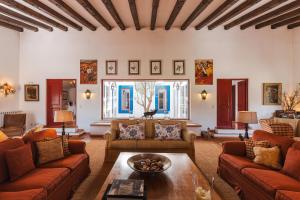 a living room with couches and a table at Charming Farm House With Pool in Ferreira do Alentejo