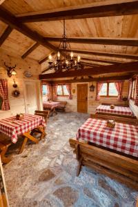 a room with two beds and a chandelier in a cabin at Albero Casa in Cetinje +162 photos