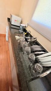 a kitchen counter with a stove with wine glasses on it at Chalés - Aquabeat in Sao Jose da Lapa