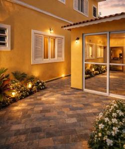 a house with a patio in front of it at GrandMaré Hotel in Peruíbe