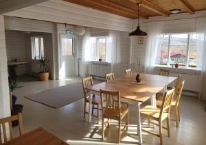 a dining room with a wooden table and chairs at Skaftholt Guesthouse in Birkikinn +17 photos