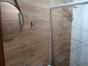 a shower with a glass door in a bathroom at Pousada Coutinho in Paraty
