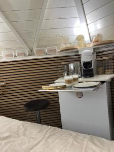 a room with a bed and a counter with a table at B&B Chalet Grillkota in Trasadingen +32 photos
