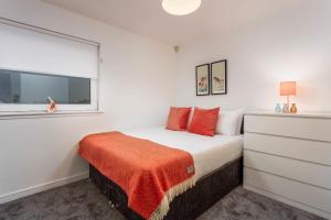 a white bedroom with a bed and a window at Walker Suite No73 - Donnini Apartments in Kilmarnock