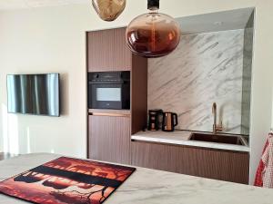 a kitchen with a sink and a counter at Vakantiewoning Koestraat 48A met strandcabine in Westkapelle