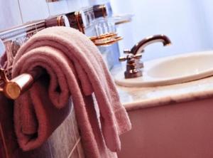 a towel hanging on a towel rack next to a sink at Ortegal Urban Suites in Mar del Plata