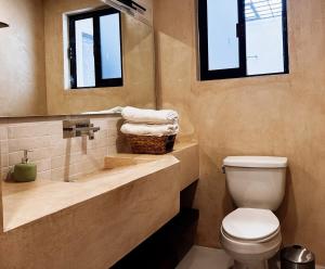 a bathroom with a toilet and a sink and a mirror at Casa San Martín, Campeche #2 in Campeche +14 photos