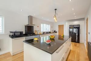 a kitchen with a large island in the middle at 4 Bed in Caernarfon oc-86423 in Pen-y-groes