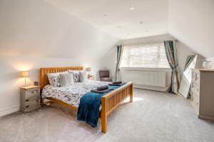 a bedroom with a large bed and a window at 4 Bed in Caernarfon oc-86423 in Pen-y-groes