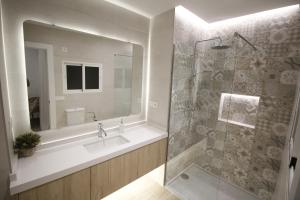a bathroom with a shower and a large mirror at LaJoya De La Villa in Priego de Córdoba +30 photos