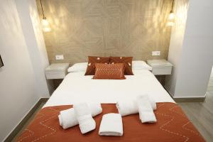 a bedroom with a large bed with towels on it at LaJoya De La Villa in Priego de Córdoba