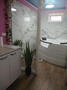 a bathroom with a tub and a toilet and a sink at Stan Na Dan Pancevo in Pančevo +5 photos