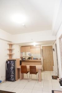 a kitchen with a table and two chairs in a room at apartment candiland room 45 m2 in Jomblang