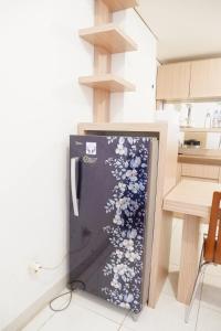 a refrigerator with flowers painted on it in a kitchen at apartment candiland room 45 m2 in Jomblang +4 photos