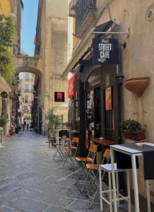 an empty street with tables and chairs outside a street cafe at B&B La Fenice Suite in Salerno