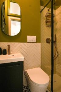 a bathroom with a sink and a toilet and a mirror at Boemondo 33 in Bari +25 photos
