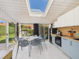 a kitchen and dining room with a table and chairs at Maison avec piscine à 200m de la plage in Saint-Michel-Chef-Chef