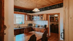 a kitchen with wooden cabinets and a wooden table at Oregon House in Riebeek-Wes