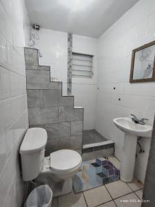 a bathroom with a toilet and a sink at Sleep relax v in Fajardo