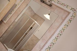 a bathroom with a toilet and a glass door at La Primavera B&B in Volterra