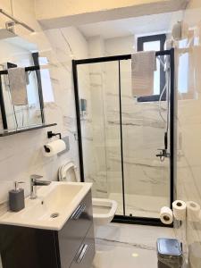 a white bathroom with a shower and a sink at MEYS Apartment 2 in Istanbul +7 photos
