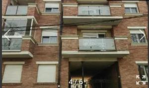 a brick building with windows and a balcony at Stan Na Dan Pancevo in Pančevo