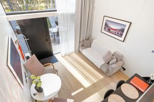 a living room with a couch and a table at Relax al Mare with sauna near the sea in Laulasmaa