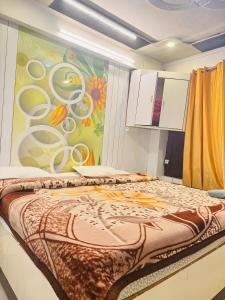 a bed in a room with a painting on the wall at hotel sunshine in Nainital