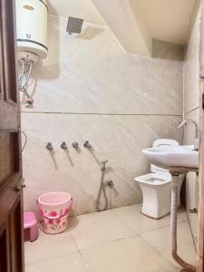 a bathroom with a shower and a sink and a toilet at hotel sunshine in Nainital