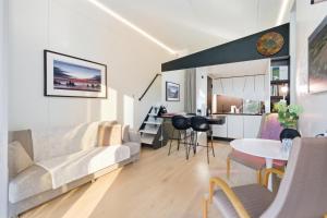 a living room with a couch and a table at Relax al Mare with sauna near the sea in Laulasmaa