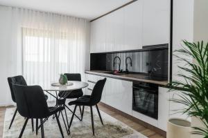 a kitchen with a table and chairs in a room at Villa Sunce in Visoko