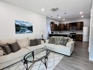a living room with a couch and a table at New 2 BR Unit in Prime Location (103) in Maryville