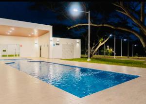 a swimming pool in front of a building at night at Casa Verde in San Miguel