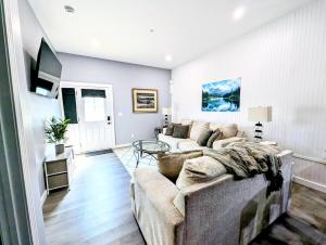 a living room with a couch and a table at New 2 BR Unit in Prime Location (103) in Maryville
