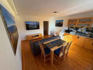 a kitchen and dining room with a table and chairs at Apartmány pri Belej in Liptovský Hrádok