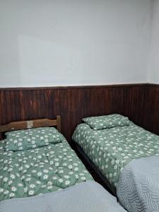 two beds sitting next to each other in a room at Casita de Florida 2 in Florida +1 photo